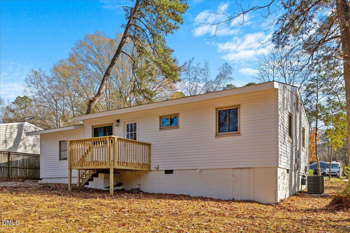 1406 Valley Road Garner, NC 27529 - Photo 33 of 39 a backyard of a house with barbeque oven table and chairs