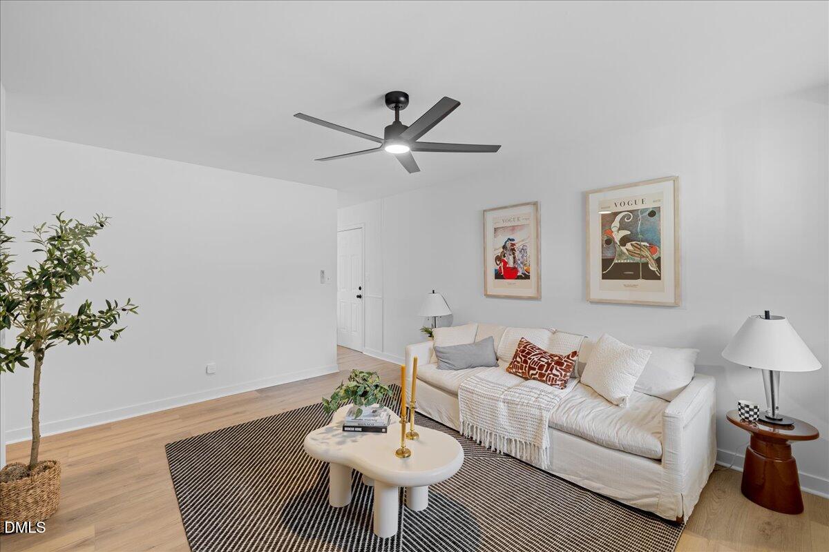 1406 Valley Road Garner, NC 27529 - Photo 8 of 39 a living room with furniture and a potted plant