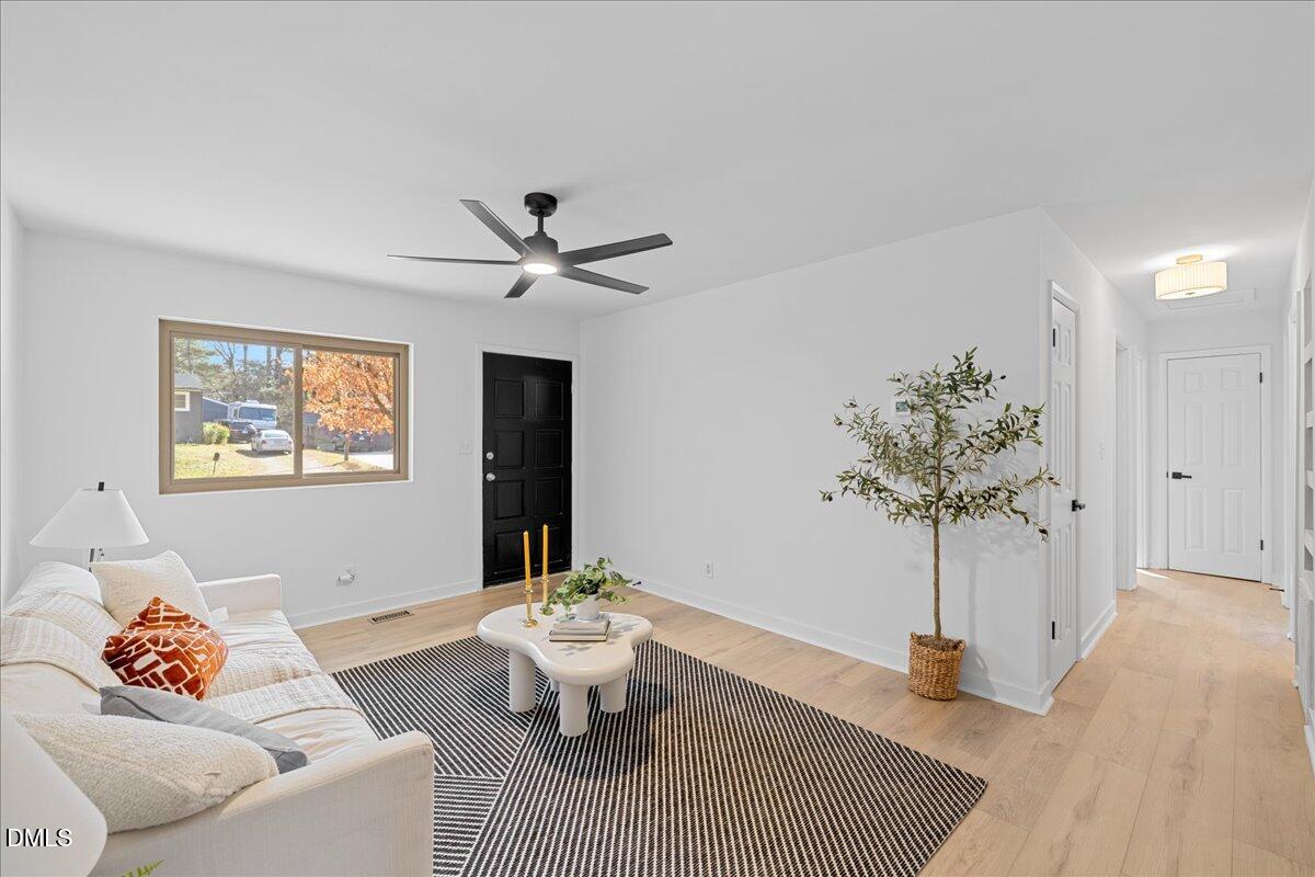 1406 Valley Road Garner, NC 27529 - Photo 9 of 39 a living room with furniture and a potted plant