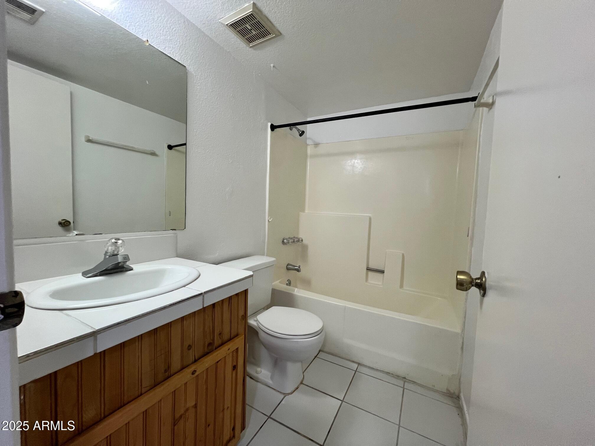 1927 East Hampton Avenue, Unit 136 Mesa, AZ 85204 - Photo 12 of 26 a bathroom with a sink a toilet and shower