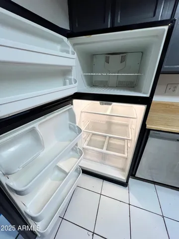 a kitchen with stainless steel appliances granite countertop a refrigerator and a stove