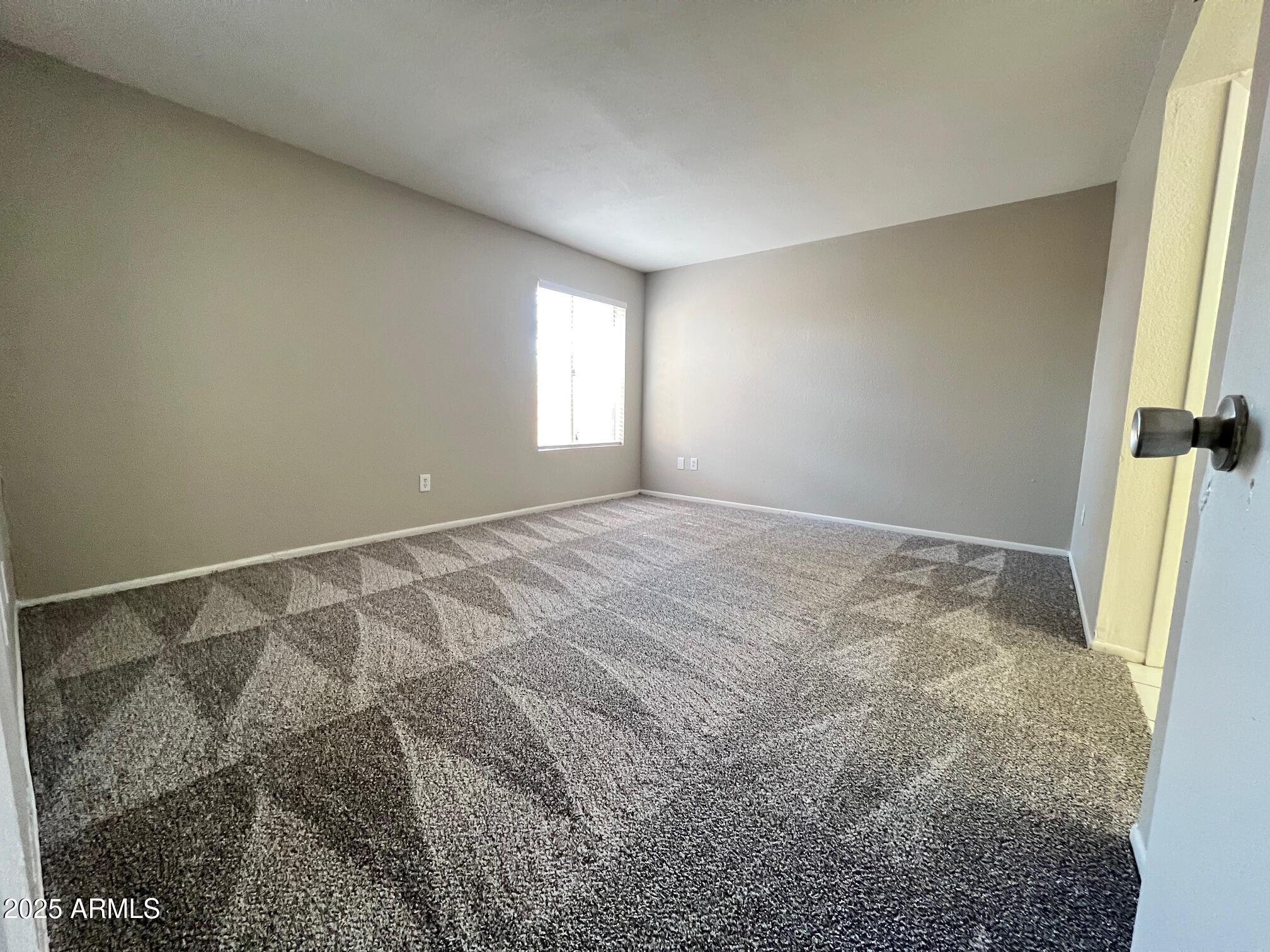 1927 East Hampton Avenue, Unit 136 Mesa, AZ 85204 - Photo 18 of 26 a view of room with window and hardwood floor