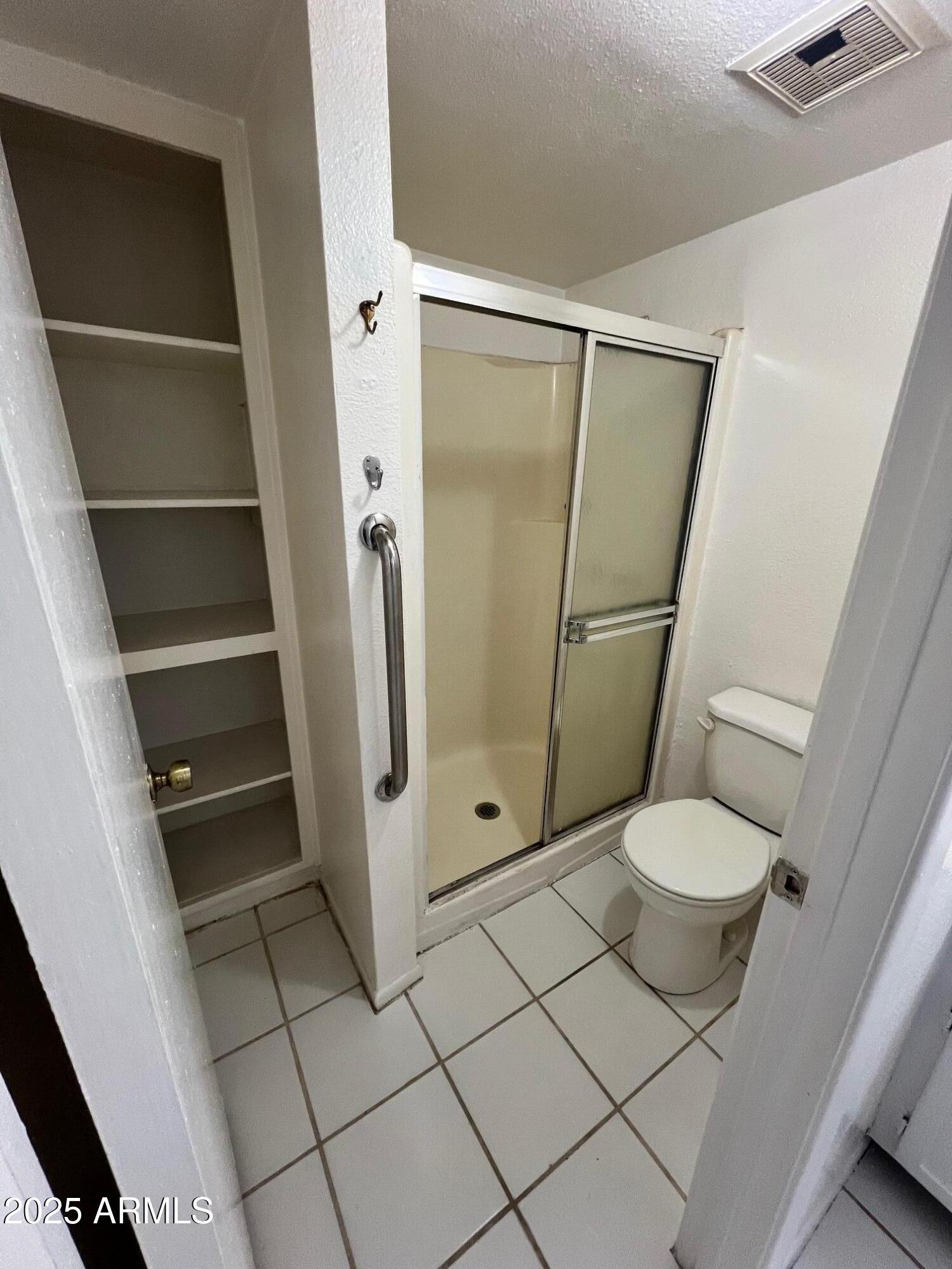 1927 East Hampton Avenue, Unit 136 Mesa, AZ 85204 - Photo 21 of 26 a bathroom with a toilet and a shower
