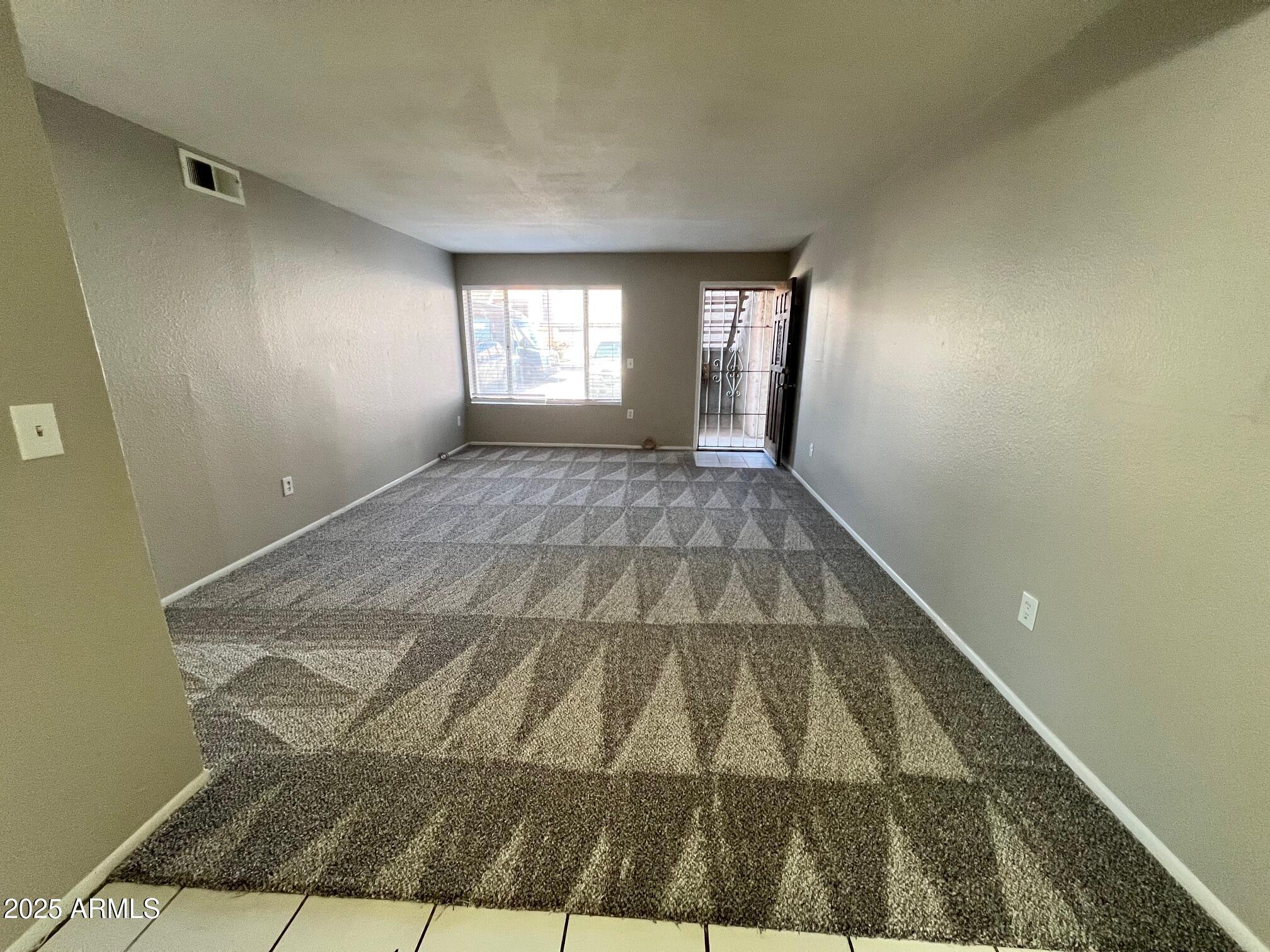 1927 East Hampton Avenue, Unit 136 Mesa, AZ 85204 - Photo 5 of 26 a view of an empty room and window