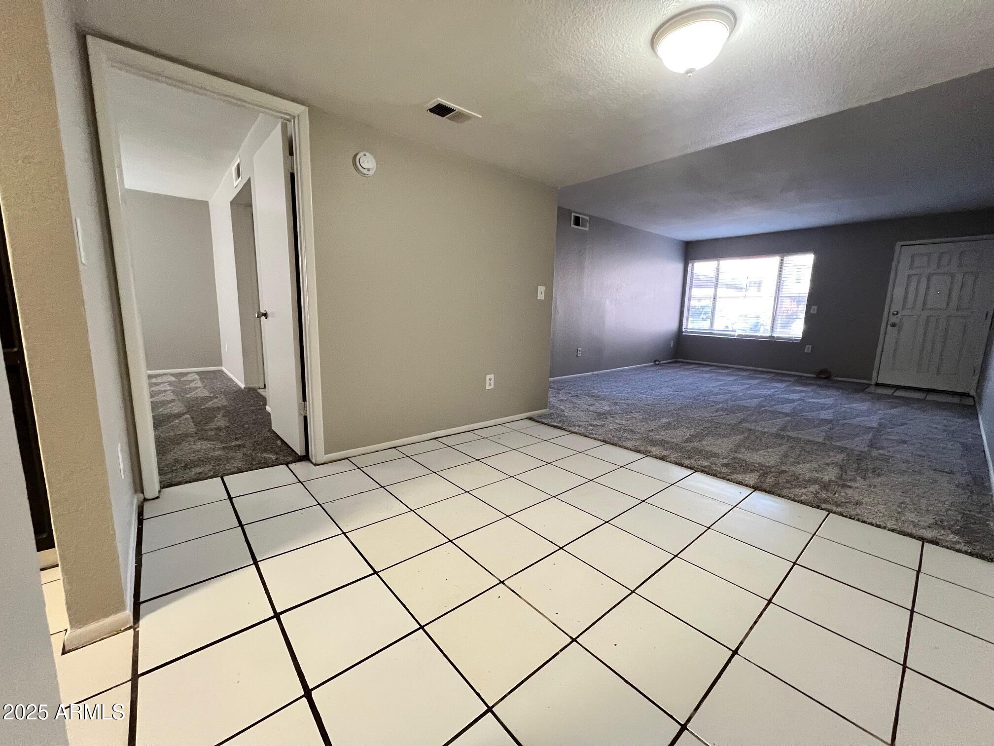 1927 East Hampton Avenue, Unit 136 Mesa, AZ 85204 - Photo 8 of 26 a view of an empty room and window