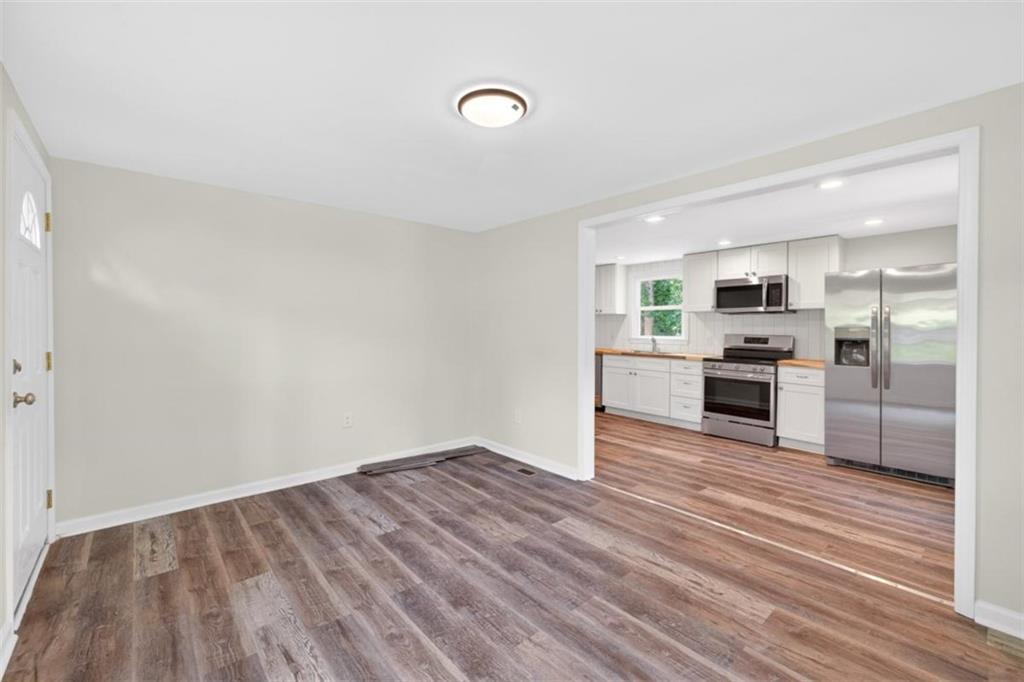 136 Nowell Street Monroe, GA 30655 - Photo 11 of 25 a view of kitchen with wooden floor and electronic appliances