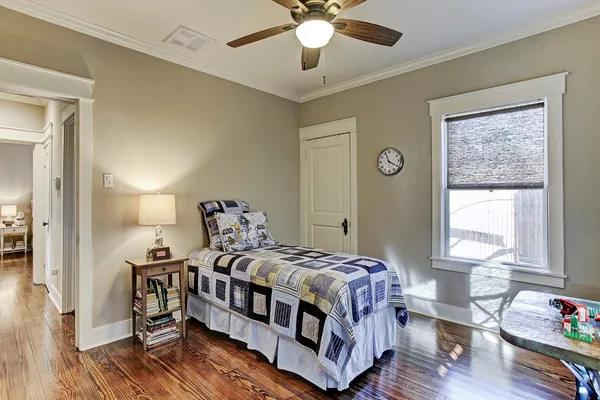 a bedroom with a bed and a chandelier