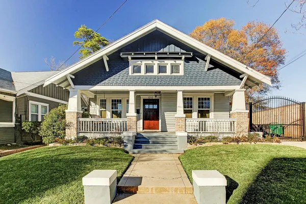 a front view of a house with a yard table and chairs