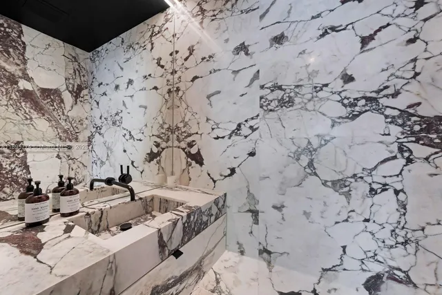 a bedroom with a bed and a floor to ceiling window