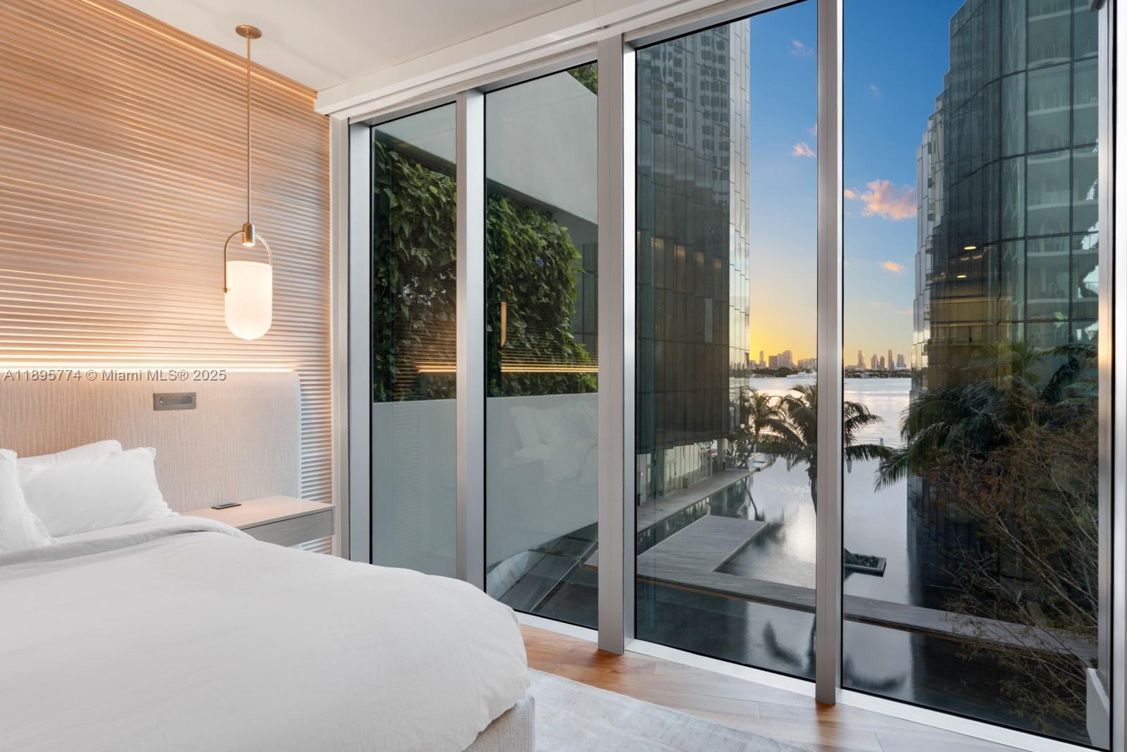 1300 Monad Terrace, Unit 3B Miami Beach, FL 33139 - Photo 16 of 35 a bedroom with a bed and a potted plant next to a window