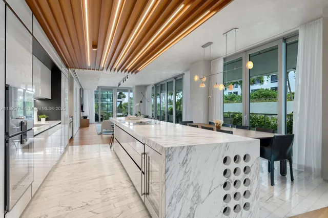 a large white kitchen with a large window