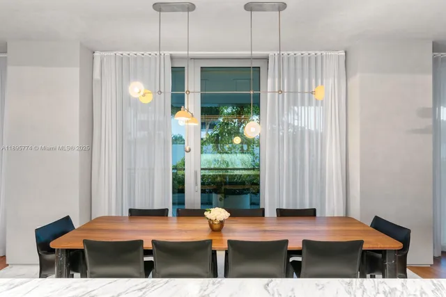 a view of a kitchen with kitchen island dining table and chairs