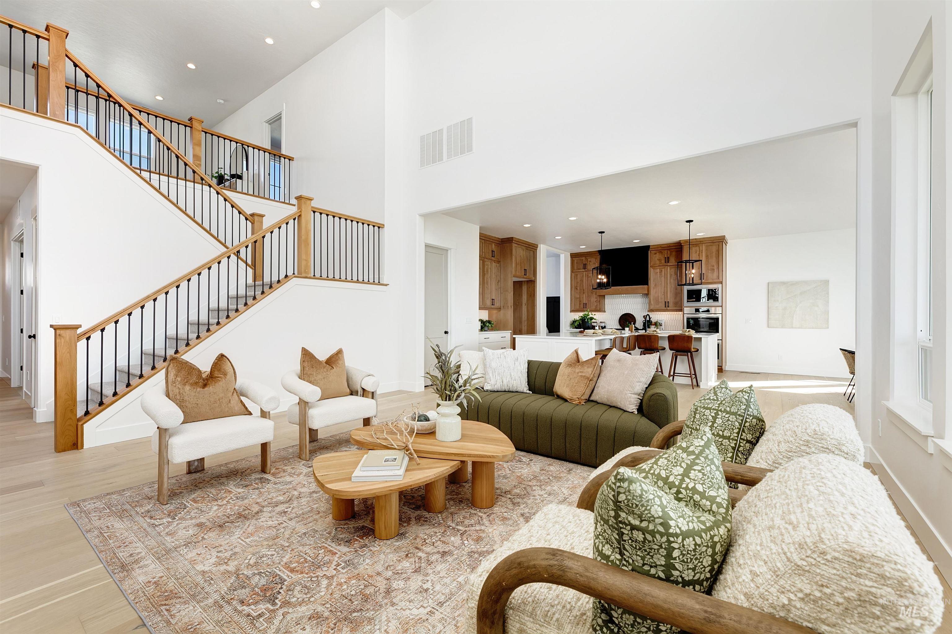 13623 North Ruffed Grouse Way Boise, ID 83714 - Photo 10 of 45 Living room with light wood finished floors, a high ceiling, recessed lighting, and stairs