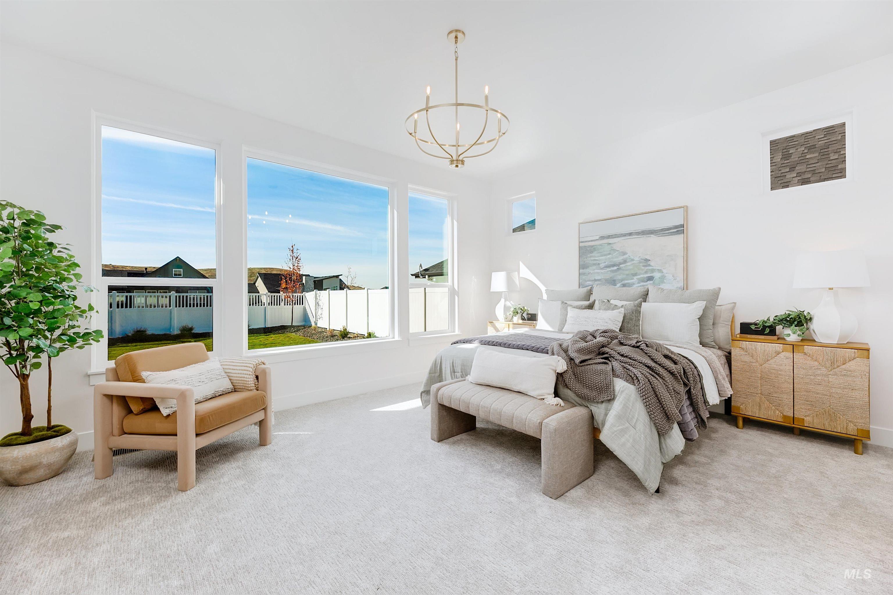 13623 North Ruffed Grouse Way Boise, ID 83714 - Photo 11 of 45 Carpeted bedroom with a chandelier and baseboards