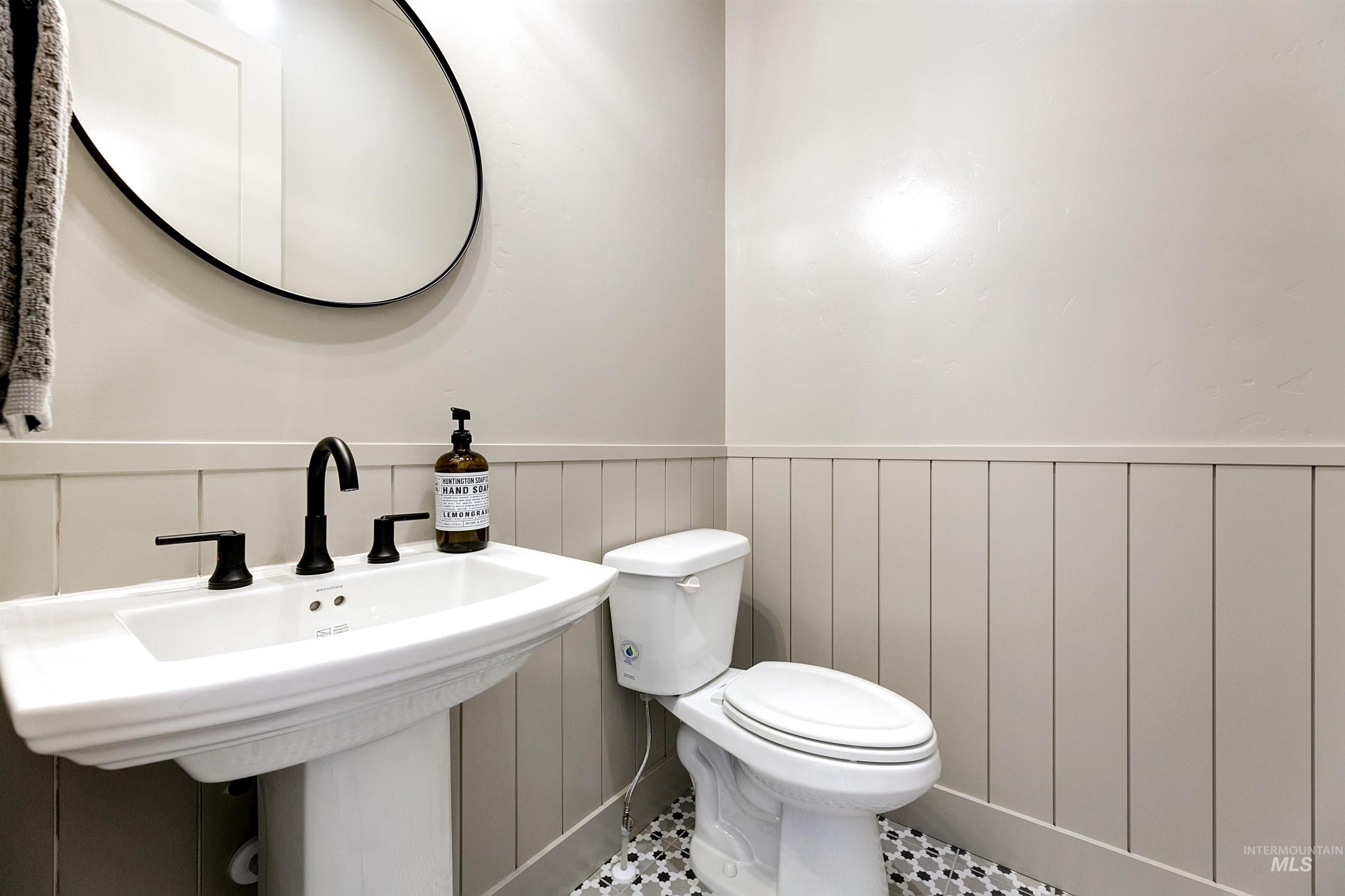 13623 North Ruffed Grouse Way Boise, ID 83714 - Photo 18 of 45 Half bathroom with wainscoting and tile patterned floors