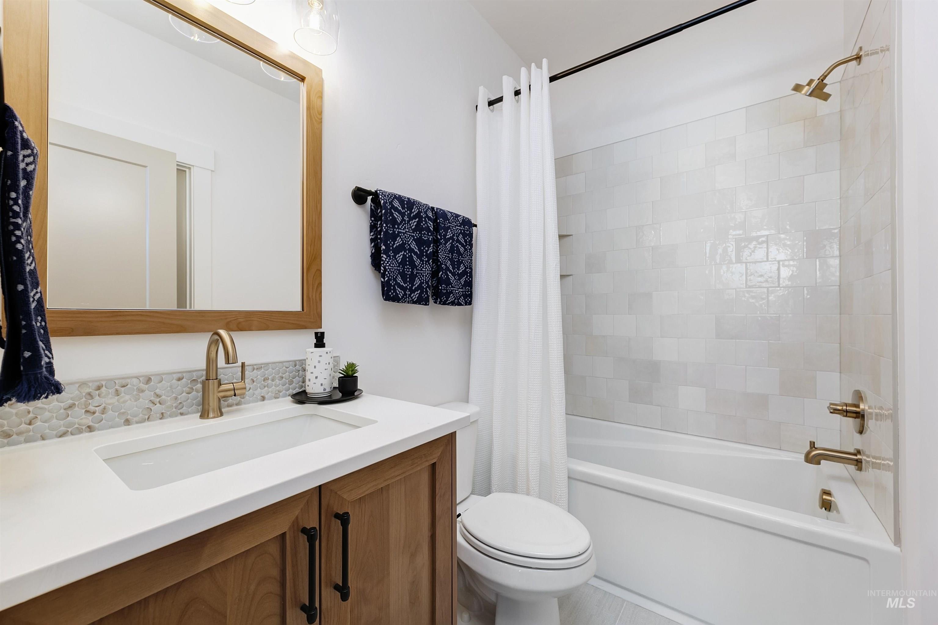 13623 North Ruffed Grouse Way Boise, ID 83714 - Photo 25 of 45 Bathroom featuring shower / bath combo with shower curtain and vanity