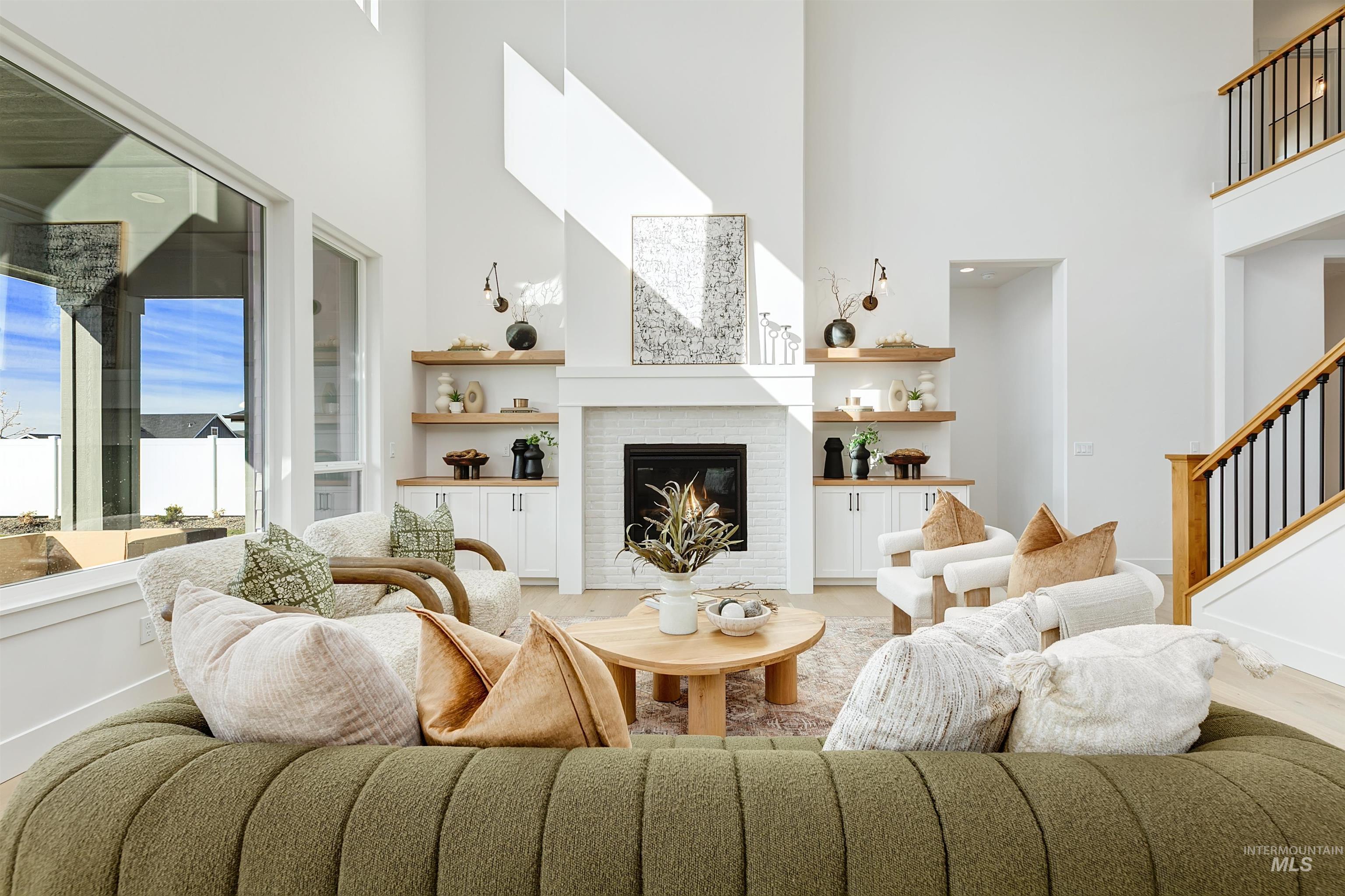 13623 North Ruffed Grouse Way Boise, ID 83714 - Photo 3 of 45 Living area with a fireplace, a towering ceiling, and stairway