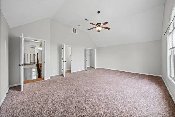 a view of empty room with ceiling fan