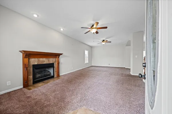 a view of an empty room and fire place