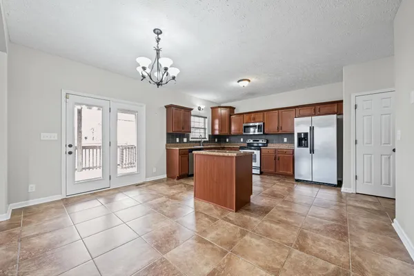 a large kitchen with cabinets and stainless steel appliances