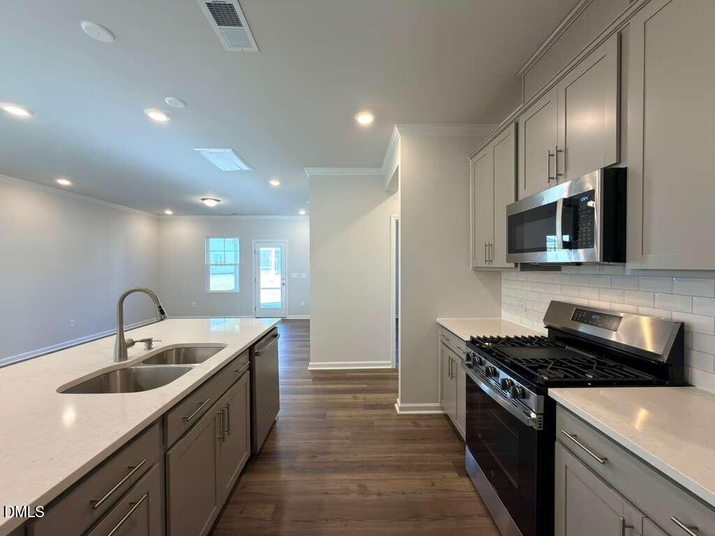 2008 English Saddle Lane Durham, NC 27703 - Photo 11 of 49 a kitchen with stainless steel appliances granite countertop a sink and a stove