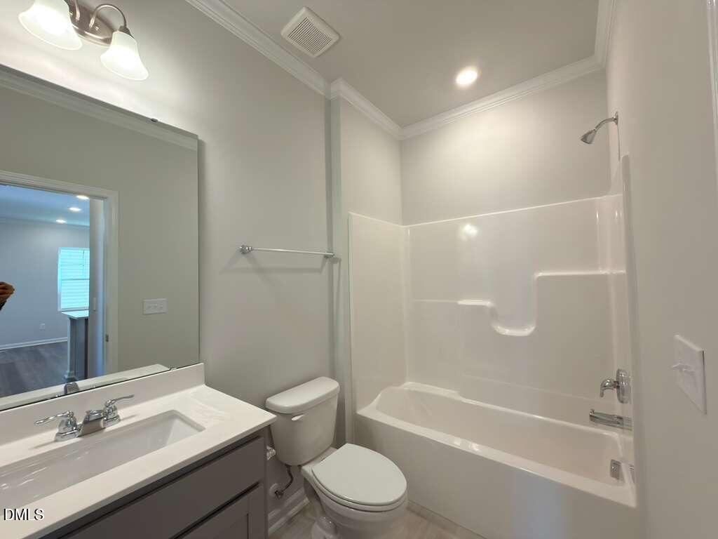 2008 English Saddle Lane Durham, NC 27703 - Photo 23 of 49 a bathroom with a granite countertop sink toilet a mirror and a bathtub