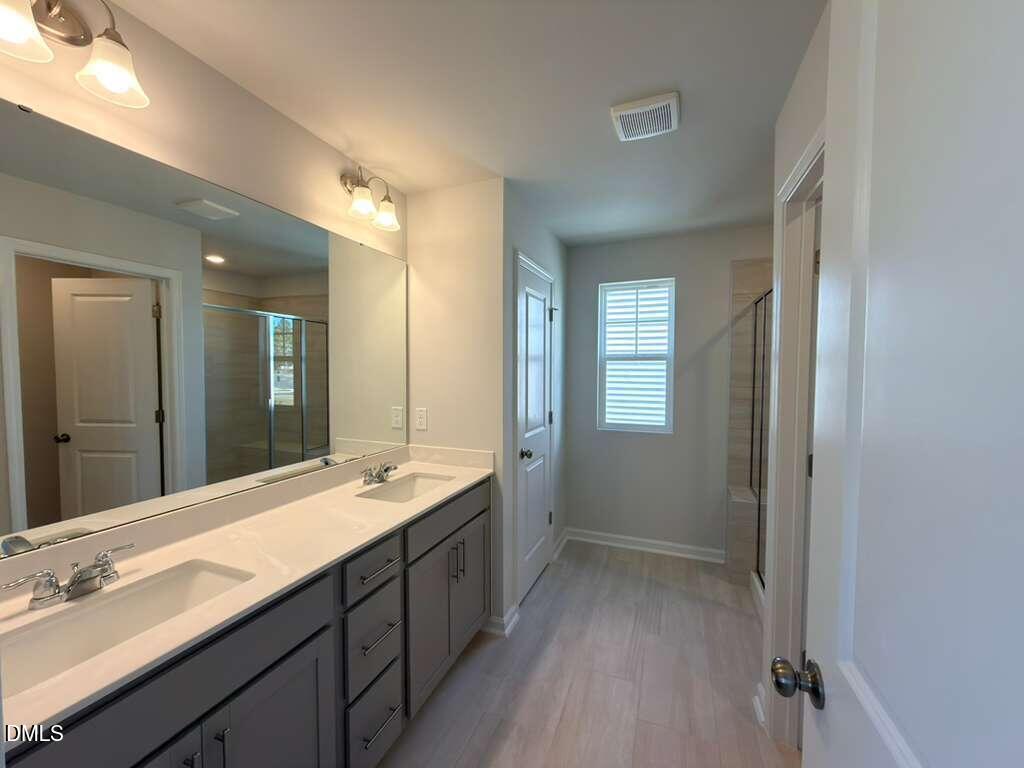 2008 English Saddle Lane Durham, NC 27703 - Photo 31 of 49 a bathroom with a sink double vanity granite tub and shower