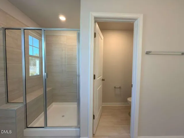 a bathroom with a glass shower door