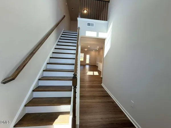 a view of entryway and hall with wooden floor