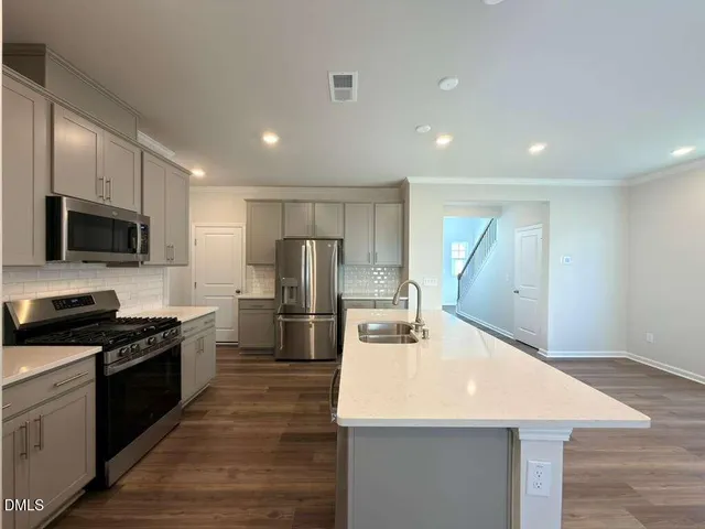 a kitchen with refrigerator and microwave