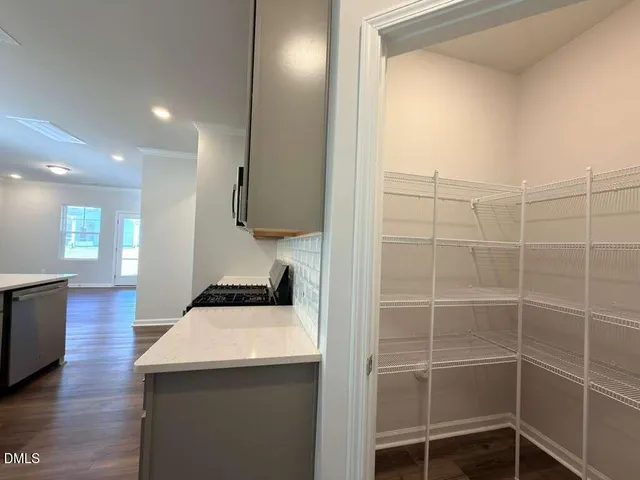 a kitchen with kitchen island a sink stainless steel appliances and cabinets