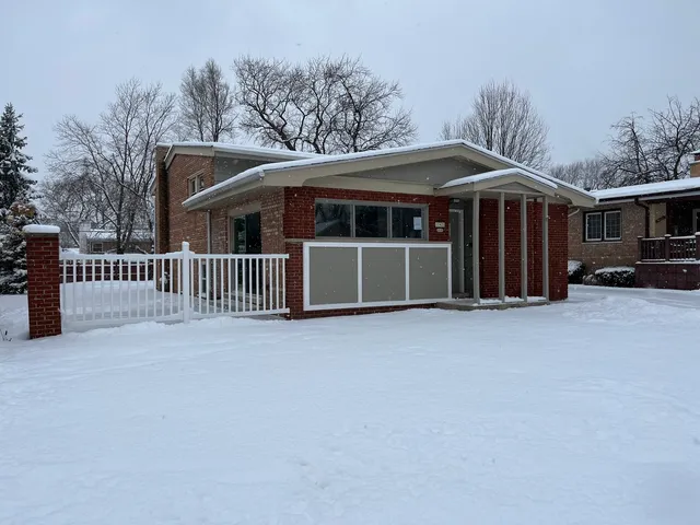 a view of a house with a yard and garage