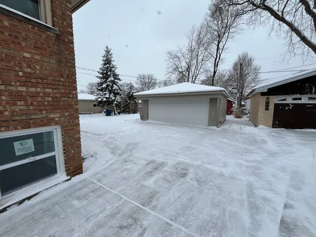 a view of a house with a snow in the yard