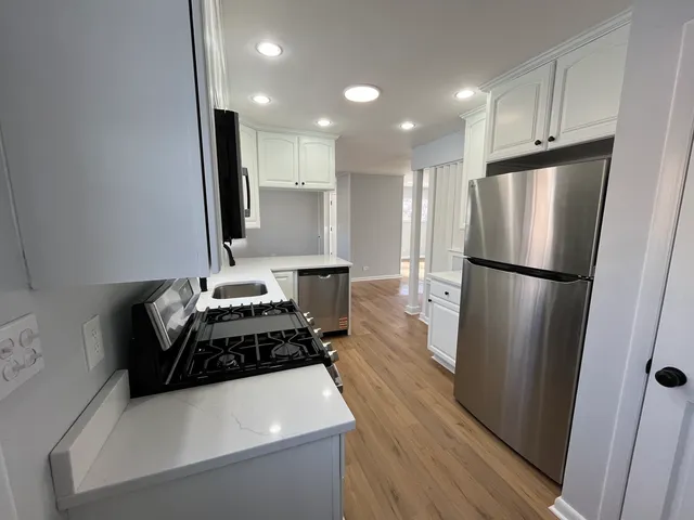 a kitchen with a refrigerator and a sink