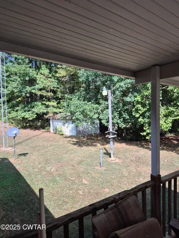 a view of a backyard with porch and furniture