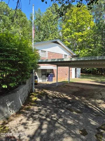 a view of house with a yard