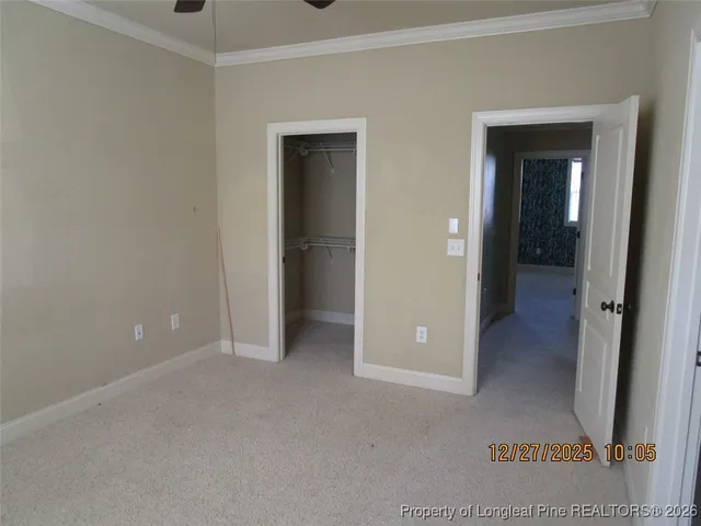 a view of a hallway with wooden shelves