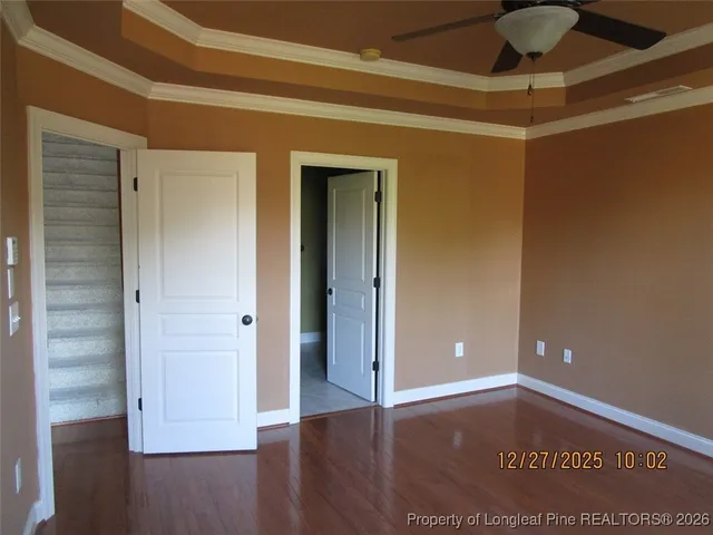 a view of an empty room with wooden floor