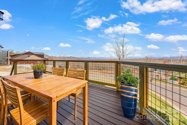 a view of a roof deck with wooden floor and fence