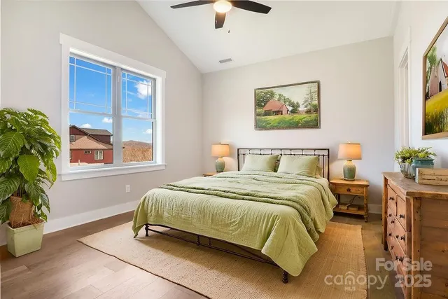 a bedroom with a bed and a potted plant