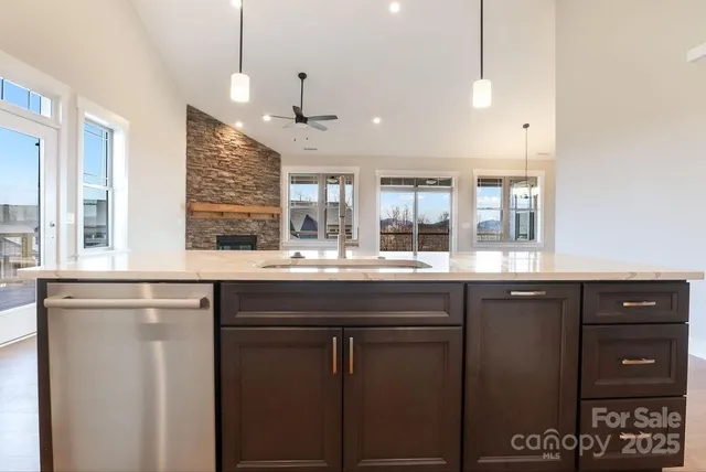 a kitchen with a sink and chandelier
