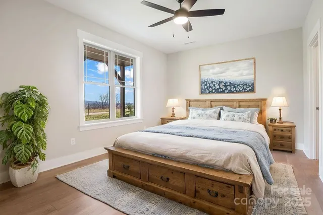 a bedroom with a bed and a potted plant