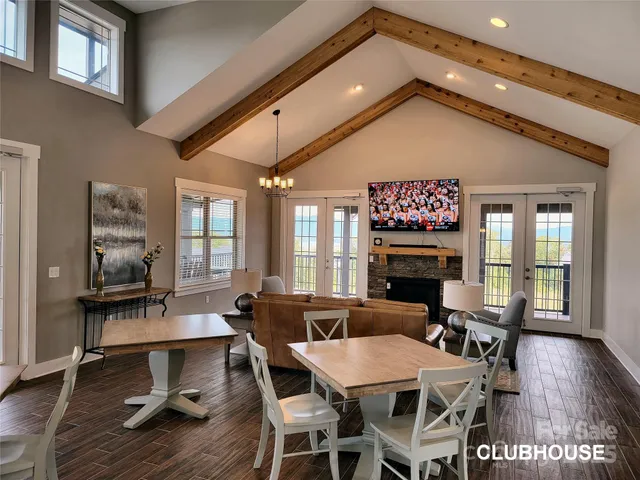a view of a dining room with furniture a chandelier and wooden floor