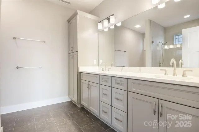 a bathroom with a double vanity sink and a mirror