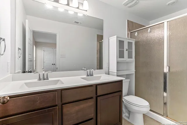 a bathroom with a sink toilet and shower