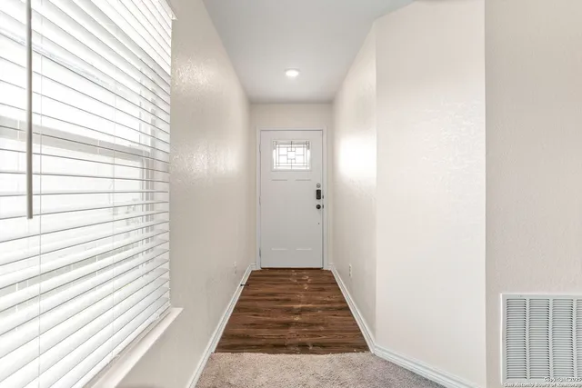 a view of a kitchen with a sink and a chandelier fan