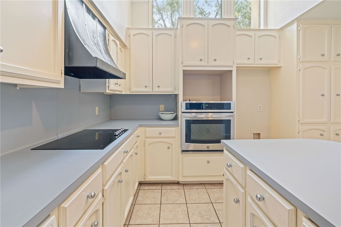 7209 Candy Ridge Road Corpus Christi, TX 78413 - Photo 10 of 24 a kitchen with granite countertop white cabinets and white appliances