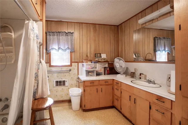 a kitchen with a refrigerator and sink