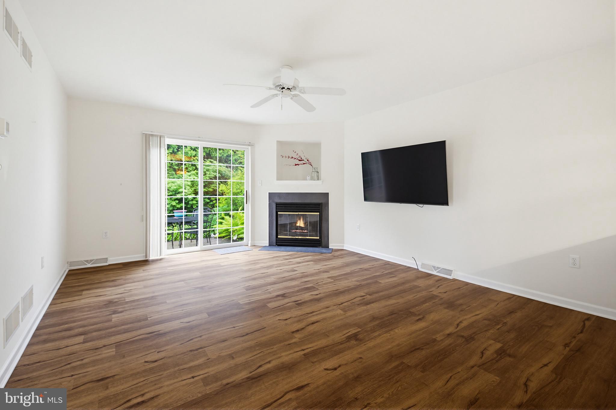 1037 Kent Garden Lititz, PA 17543 - Photo 15 of 31 en empty room with fireplace and wooden floor