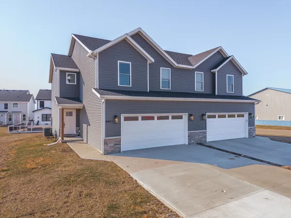 a view of a house with a door and wooden walls